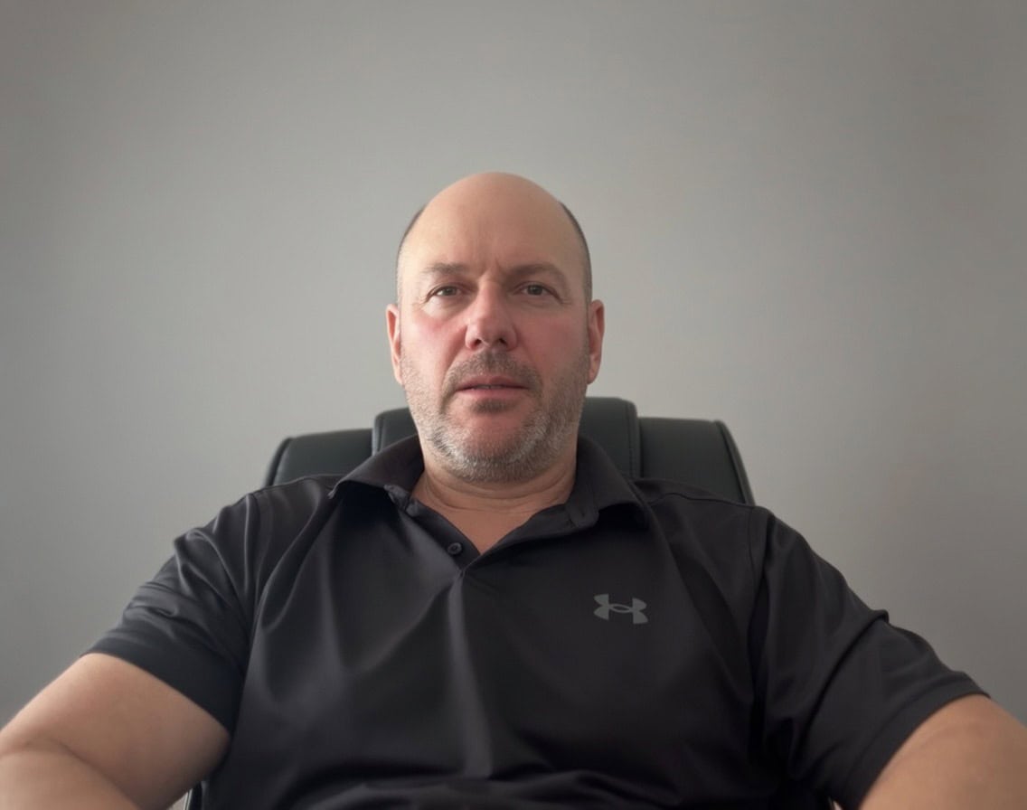 Man sitting confidently in an office, promoting mental health transformation in Cape Town.